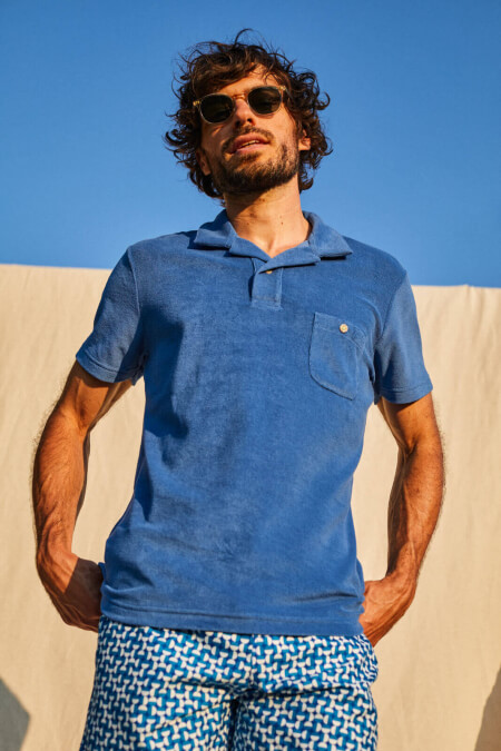 man wearing a blue terry cloth polo