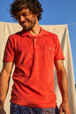 man wearing a terracotta terry cloth polo