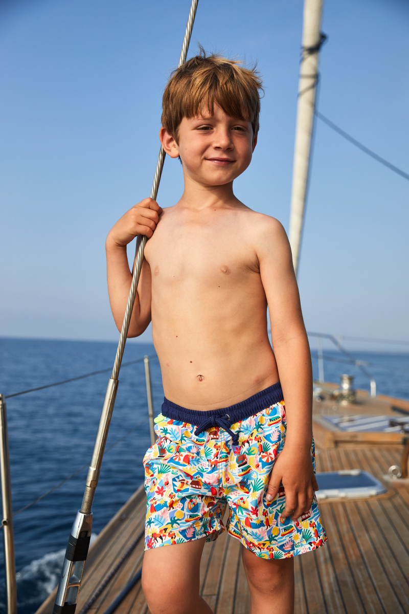 Boy wearing a swimsuit with buttoned belt Meno Surf with Claire Prouvost