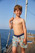 Boy wearing a swimsuit with buttoned belt Meno Surf with Claire Prouvost