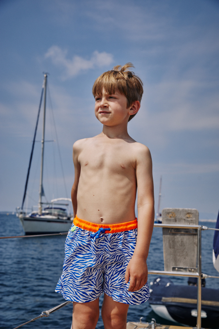Boy wearing a swimsuit with buttoned belt Meno Electric Zebra