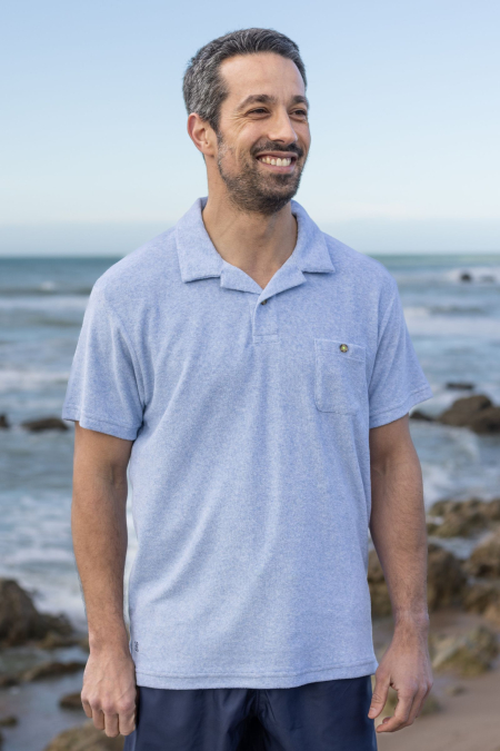 Man wearing a blue terry cloth polo