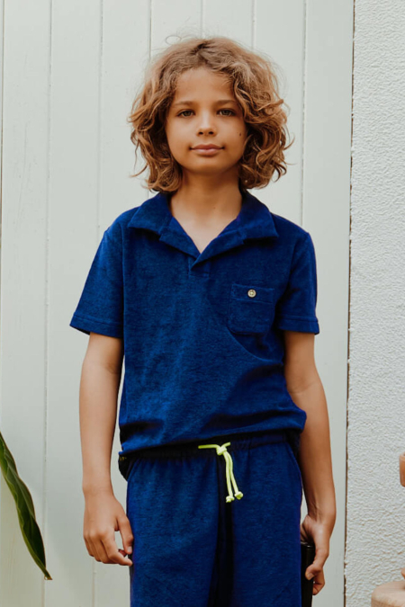 kid wearing navy terry cloth polo